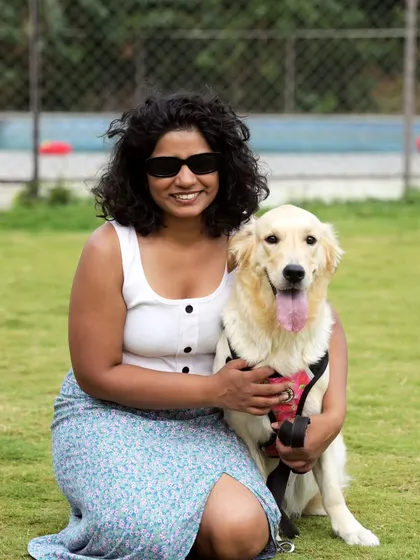 A beautiful moment between a dog mom and her smiling Golden Retriever on our green lawn.