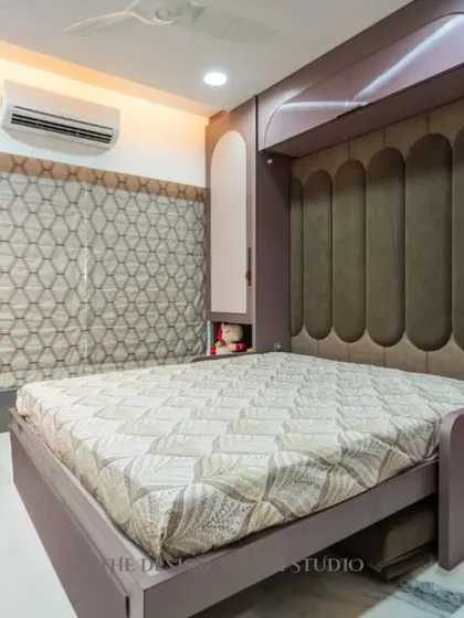 Here is the magic. The sofa is removed, and the wall unit folds down to reveal a full-sized, comfortable bed with a plush, upholstered headboard. This is how we create a bedroom that appears out of nowhere.