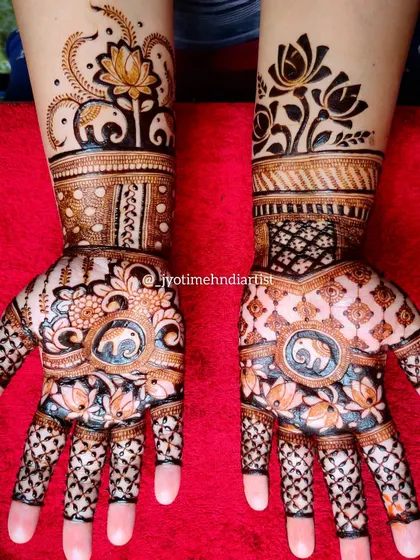 A lovely bridal design featuring elephant and lotus motifs. The patterns are different on each hand but complement each other perfectly.