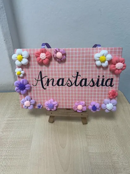 Anastasiia's nameplate with pretty pink and purple flowers. The kids love taking these home to hang on their doors.
