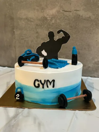 For the gymaholic in your life. This cake is decorated with fondant gym equipment like barbells, a gym bag, and a silhouette of a bodybuilder.
