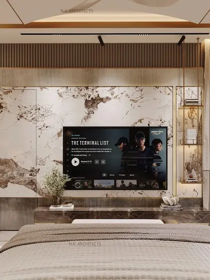 A close-up of a modern master bedroom TV wall. We used a stunning book-matched marble panel that conceals storage, creating a seamless and luxurious feature wall.