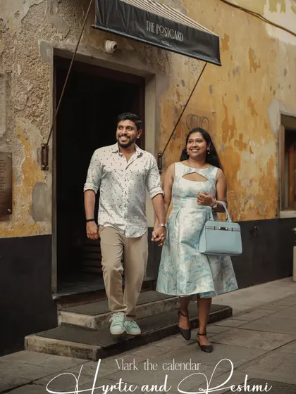 A candid "save the date" photo of a couple walking out of a building with "The Postcard" sign, adding a story-like element to their announcement.