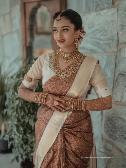 A portrait of timeless South Indian bridal beauty. I focus on capturing the intricate details of the silk saree, the temple jewelry, and the bride's serene expression.