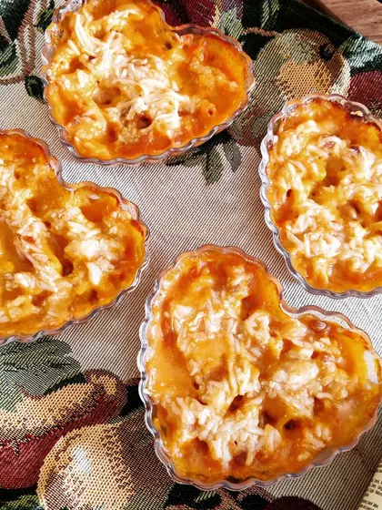 A special Valentine's treat of heart-shaped cheesy macaroni, baked until golden, showing how we can customize dishes for your special occasions.