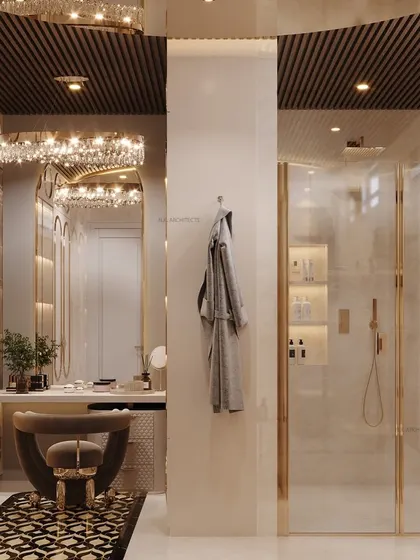 A view of the vanity and shower area in the luxurious dressing room. The design uses crystal chandeliers and gold accents to create a glamorous and cohesive space.