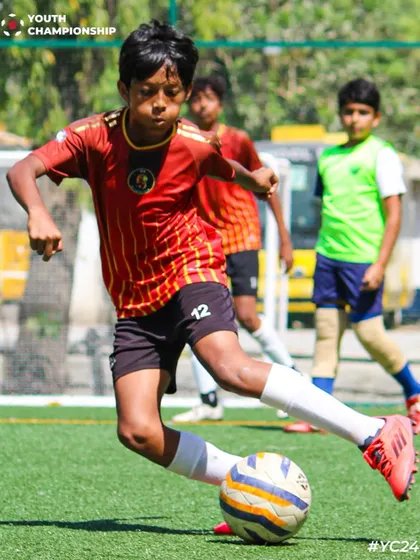 A young player shows excellent technique and ball control under pressure.