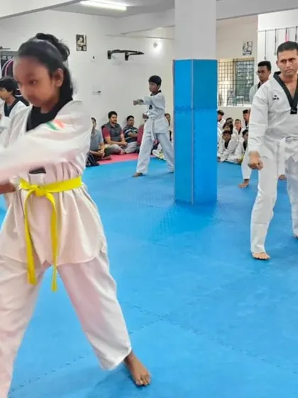 The entire class practices their forms with synchronized movements.