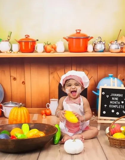 Look at that smile! This is from a nine-month milestone session, capturing the pure joy and budding personality of a baby. The little chef theme is a fun way to document this stage, showing how much they've grown.