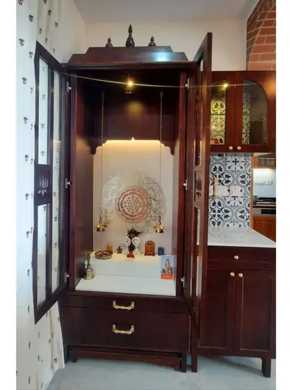 Another view of the pooja unit with its glass doors open, revealing the beautifully lit interior. The design allows for both open display and enclosed sanctity.