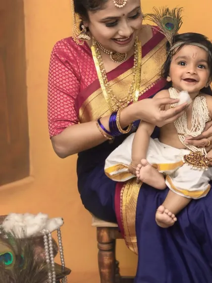 A close-up of 'Yashoda' feeding her little 'Krishna' a piece of butter. It is these small, authentic moments that bring so much life and joy to our mythological photoshoots.