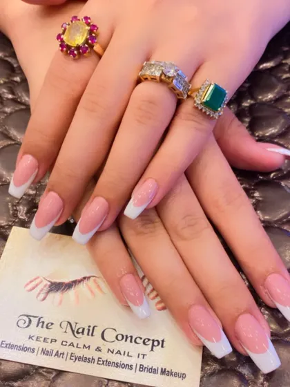 A beautiful, classic French manicure on long, square-shaped nails. The sheer pink base and bright white tips create a sophisticated and glamorous look.