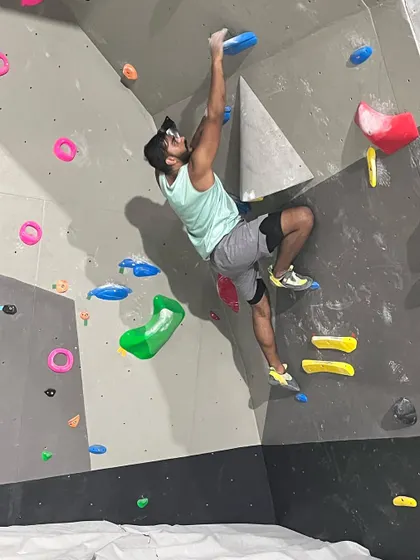 The focus is real. A climber carefully plans his next move on a challenging bouldering problem. Every climb is a new puzzle to solve, making it an exciting mental and physical workout.