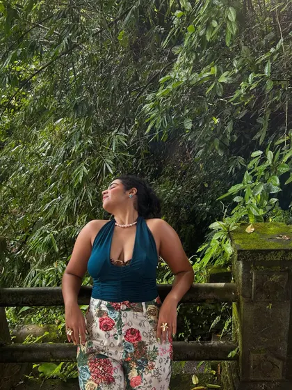 Soaking up the sun in the Ubud jungle. The lush green background makes the colors of my floral pants and teal top pop even more.