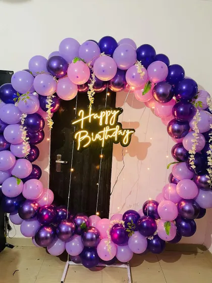 We love working with color, as shown in this beautiful purple-themed birthday ring. The design uses various shades from deep purple to soft lavender, creating a visually stunning backdrop that stands out in any room.