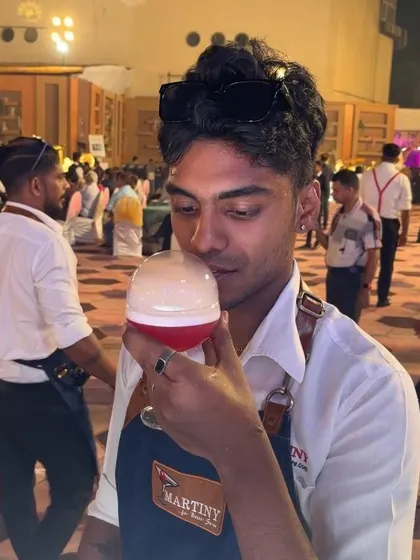 A guest or bartender enjoying the aroma from our signature 'Bubble Pop' cocktail before drinking it.