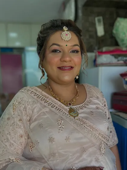 A smiling portrait showing her complete look. She looks graceful and ready for the wedding ceremony.