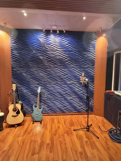 Another angle of our live room, highlighting the acoustic treatment and instrument setup. We have guitars available, and the wooden flooring adds to the warm acoustics of the space.