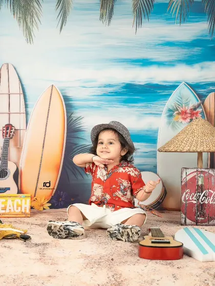 This beach boy is striking a pose. The vibrant backdrop and sandy floor make it feel like a real seaside vacation.