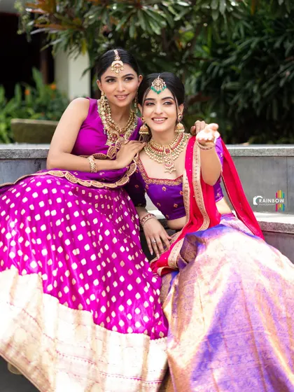 A fun and interactive shot of the two models, capturing a moment of connection and friendship.
