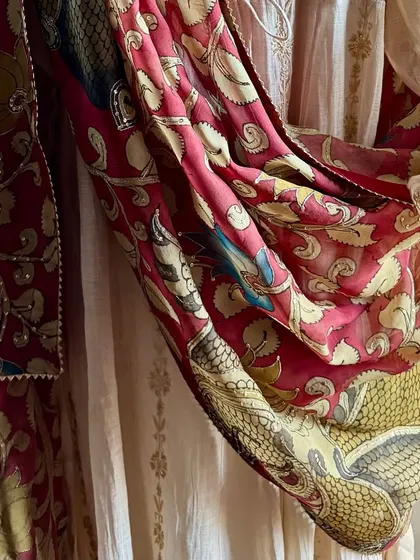 This image provides a side view of the draped Anarkali, highlighting the kasab work on the sleeves and the rich texture of the hand-painted dupatta.