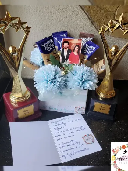 Another view of the celebration combo, showing the personalized trophies and the snack-filled bouquet.
