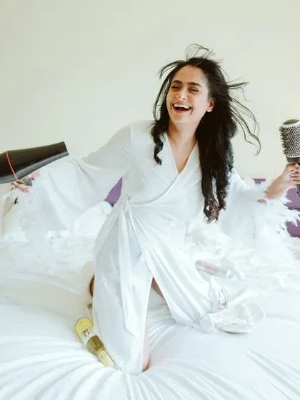 A moment of pure, uninhibited joy as the bride gets ready. This fun and energetic shot perfectly captures her personality.