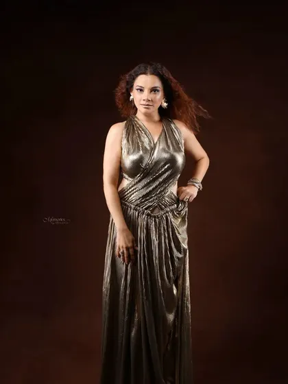 A full-length portrait showcasing a look of pure glamour and power. The metallic dress and confident pose make this a standout image for any professional or personal portfolio.