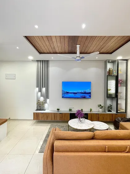 From this angle, you can see the clever use of wall decor, including a gallery of family photos and a large, decorative clock, which adds a personal and functional touch to the space.