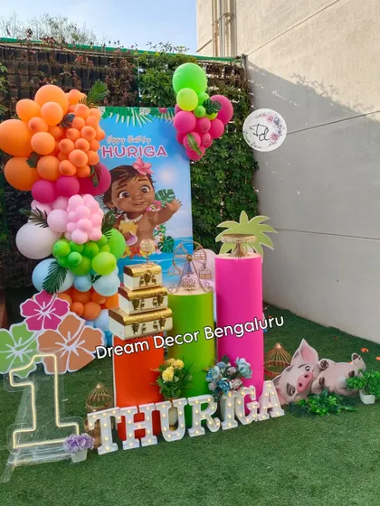 This Moana first birthday decor is perfect for an outdoor or garden party. The bright colors stand out beautifully against the green grass.