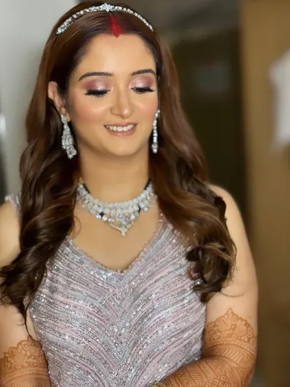 A close-up of the reception makeup. The skin is glowing, and the eyes have a beautiful, soft shimmer.