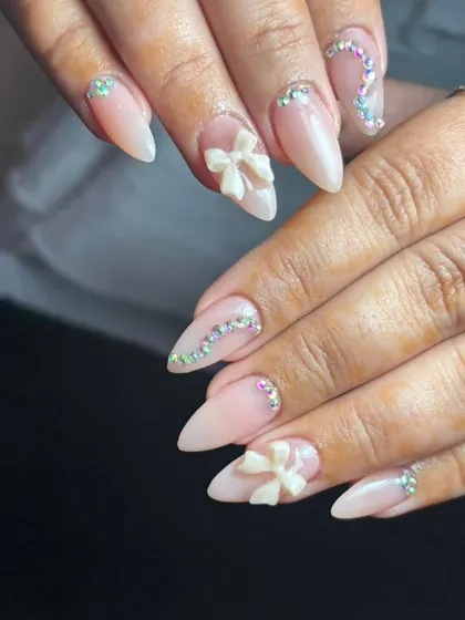 This design shows my delicate 3D nail art. I sculpted these white acrylic bows by hand and paired them with perfectly placed iridescent crystals on a natural-looking nude base for a soft, feminine look.