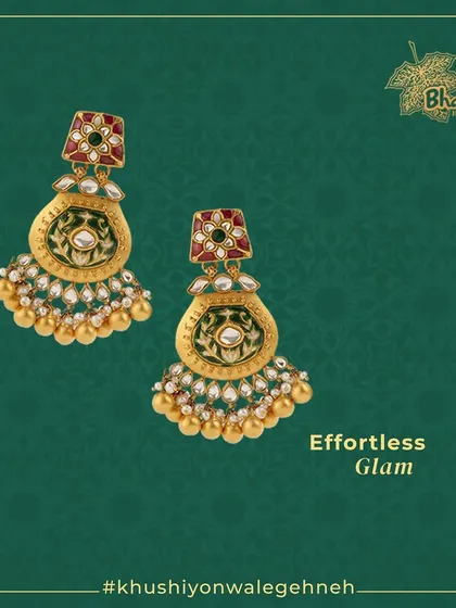 Effortless glam defined. These stunning Meenakari earrings feature intricate designs embellished with moti, kundan, and pearls. The pot-shaped design with golden bead drops adds a touch of traditional charm.