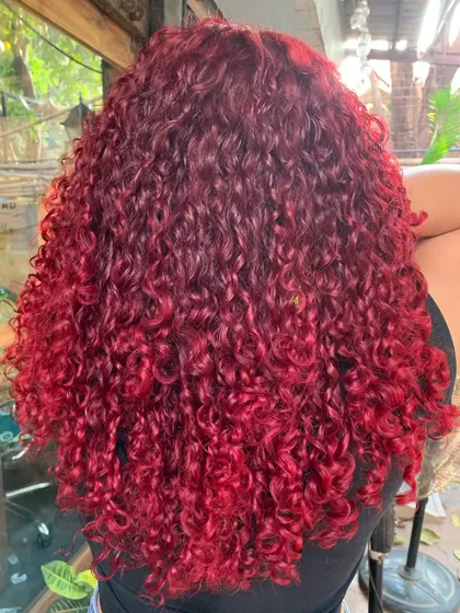 FIESTY RED. A bright and bold global red for these luscious curls. This is a non-bleach color. (No filter)