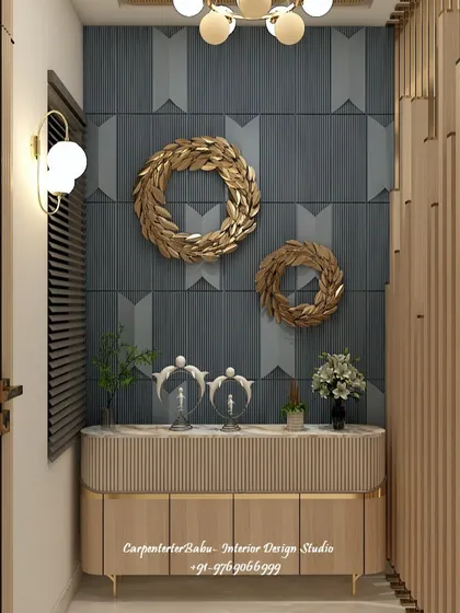 A close-up of the entryway console, featuring a textured wall, gold decorative wreaths, and a sleek wooden cabinet. It's a luxurious and welcoming vignette.