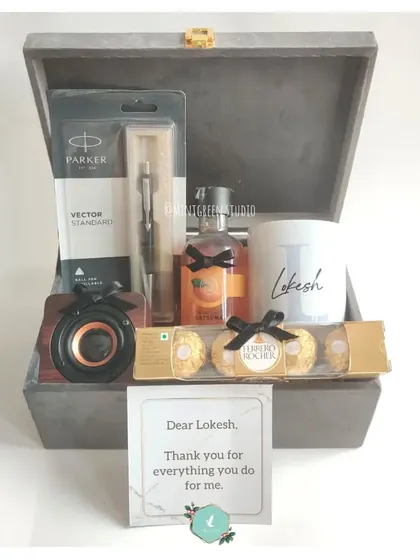 A gift to say "Thank You." This appreciation hamper features a classic Parker pen, a personalized mug, a portable speaker, and Ferrero Rocher chocolates, all packed in a premium grey suede box.
