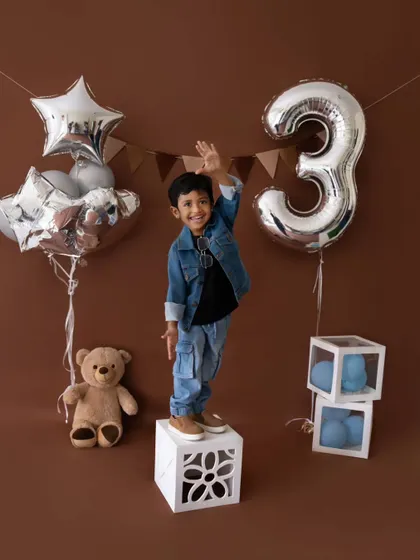 This cool dude is turning three! A fun and stylish birthday shoot with a denim theme, complete with balloons and a teddy bear companion.