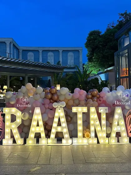 A slightly different angle of the illuminated name sign, showing its placement against the modern architecture of the venue.