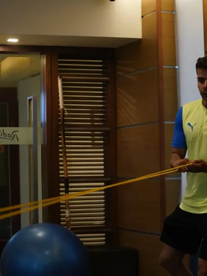 Demonstrating a resistance band exercise. Proper technique is crucial for both effectiveness and safety.