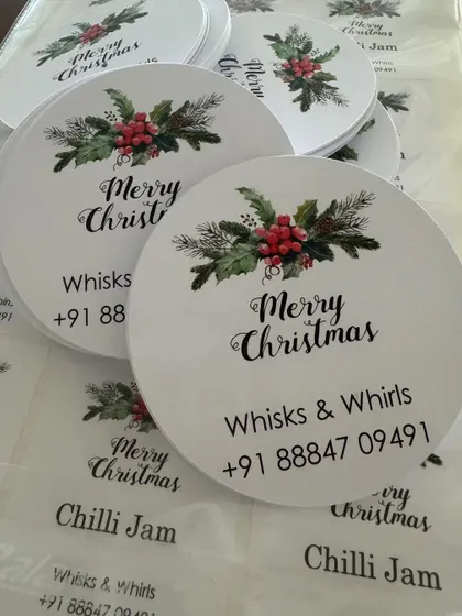 Custom-printed 'Merry Christmas' tags with contact information, perfect for attaching to holiday hampers and gifts.