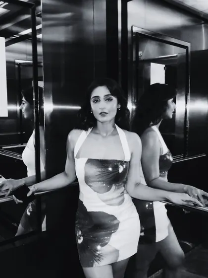 This black and white photo has a cool, moody, and artistic feel. The elevator reflections create a very cinematic effect.