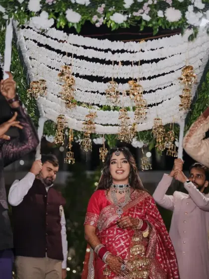 The bride's grand entrance under a 'phoolon ki chadar', a moment filled with emotion and tradition.