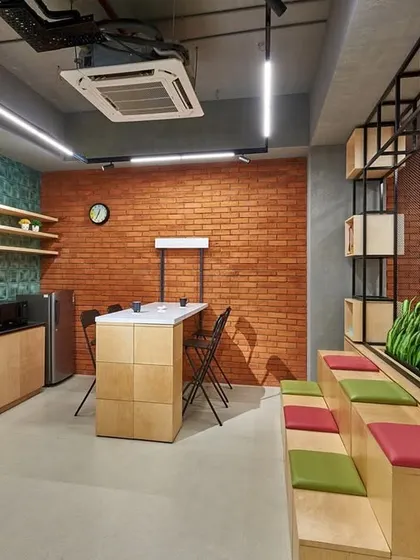 The reception area from another angle, showing the integration of a small pantry and high-top table. This makes the space more of a social hub than a formal waiting area.