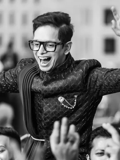 The same moment of celebration, captured in timeless black and white. This emphasizes the emotion and energy of the dance, creating a powerful memory.