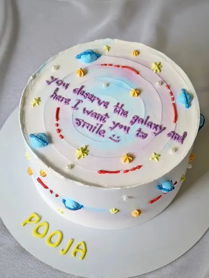 A galaxy-themed cake with a sweet, personalized message. The watercolor buttercream creates a beautiful cosmic effect.