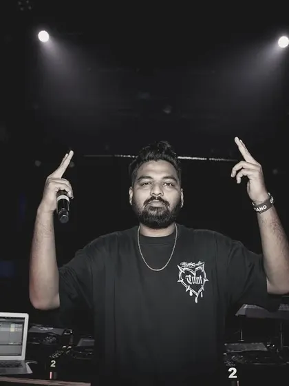 Facing the camera with both hands up. I'm here to lead the party and make sure everyone is having the best time.