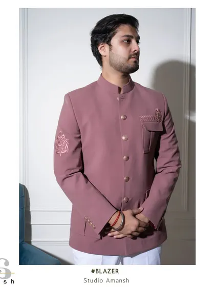 A diptych showing both a side profile and a close-up of the sleeve embroidery on our pink Prince Coat. This highlights the jacket's sharp tailoring and the delicate, tonal floral artwork.