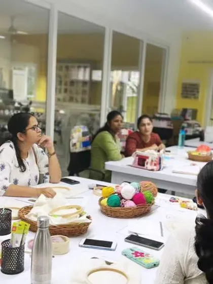 Here I am, explaining the nuances of punch needle fabric and tools to an attentive group. I make sure everyone understands the fundamentals before they start their projects.