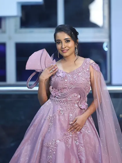Another angle of this beautiful pink gown look. The makeup enhances her features with a gentle contour and a healthy, glowing blush.