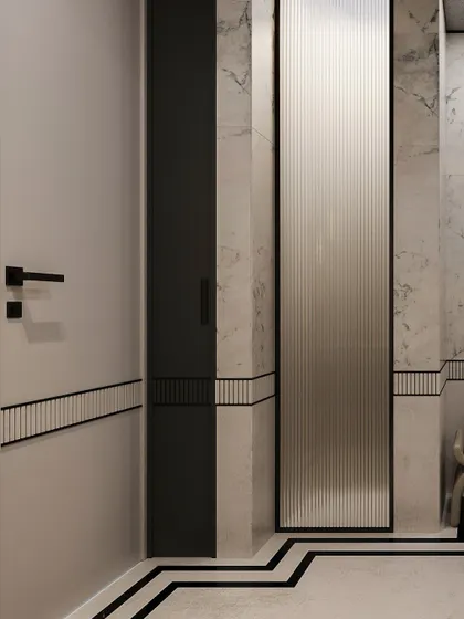 A detail of the bathroom's material palette, showing the fluted glass panel, marble walls, and the geometric black inlay on the floor.